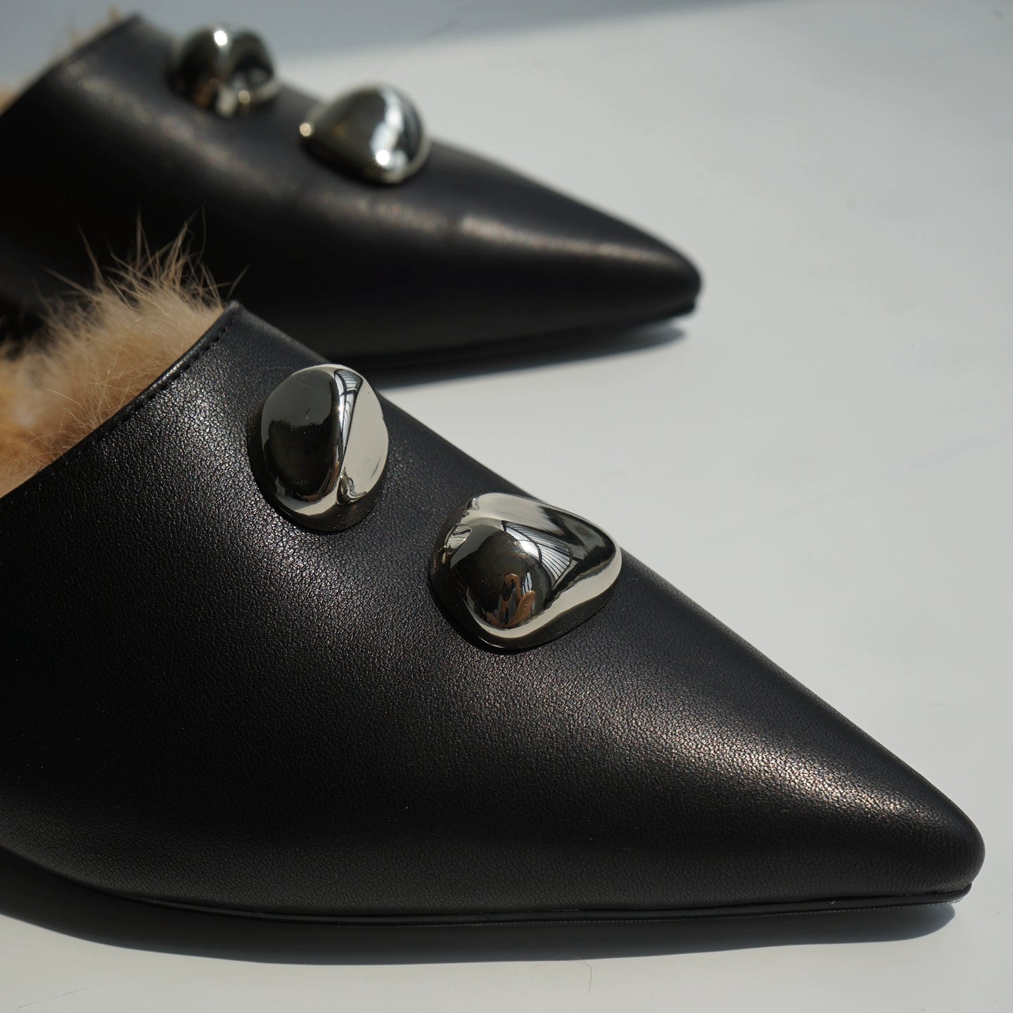 B-FEI black leather single shoe with metal buckle.