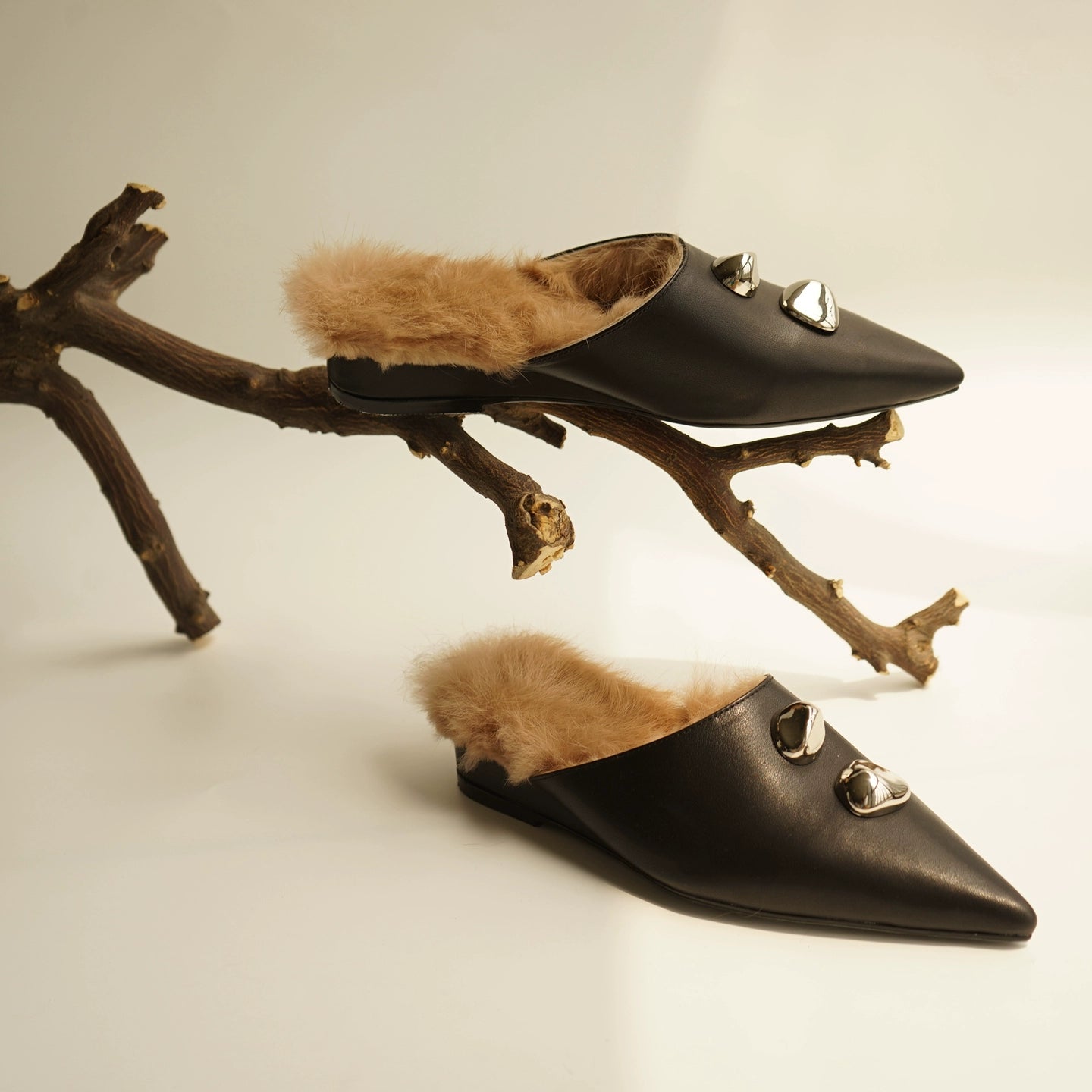 B-FEI black leather single shoe with metal buckle.