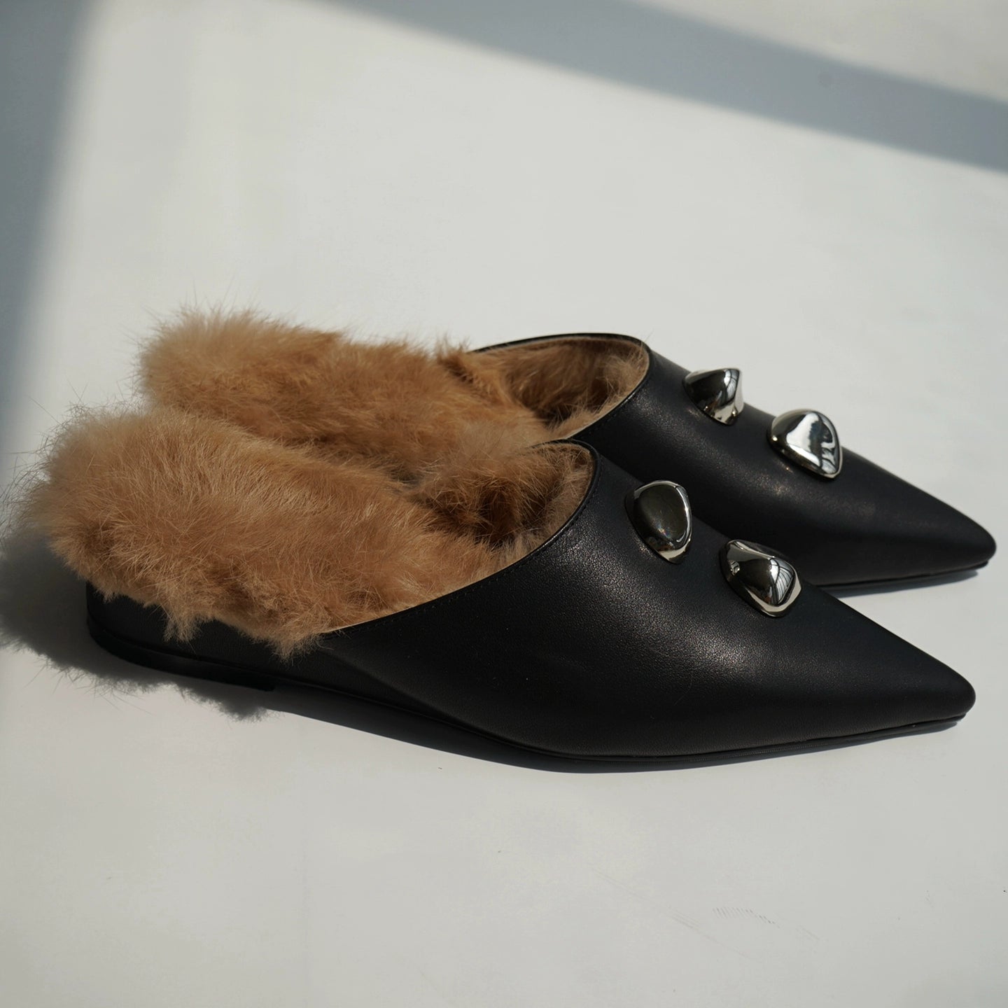 B-FEI black leather single shoe with metal buckle.